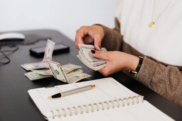 crop-payroll-clerk-counting-money-while-sitting-at-table.jpg crop-payroll-clerk-counting-money-while-sitting-at-table.jpg